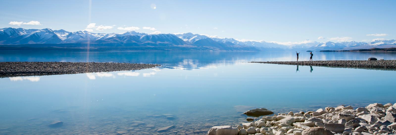 Couple exploring Lake Pukaki in Mount Cook National Park